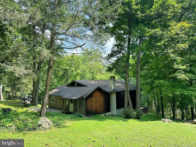 a view of a house with a yard and tree