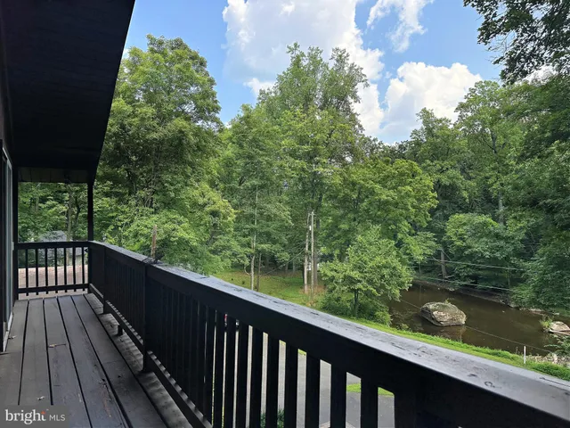 a balcony with wooden floor and fence