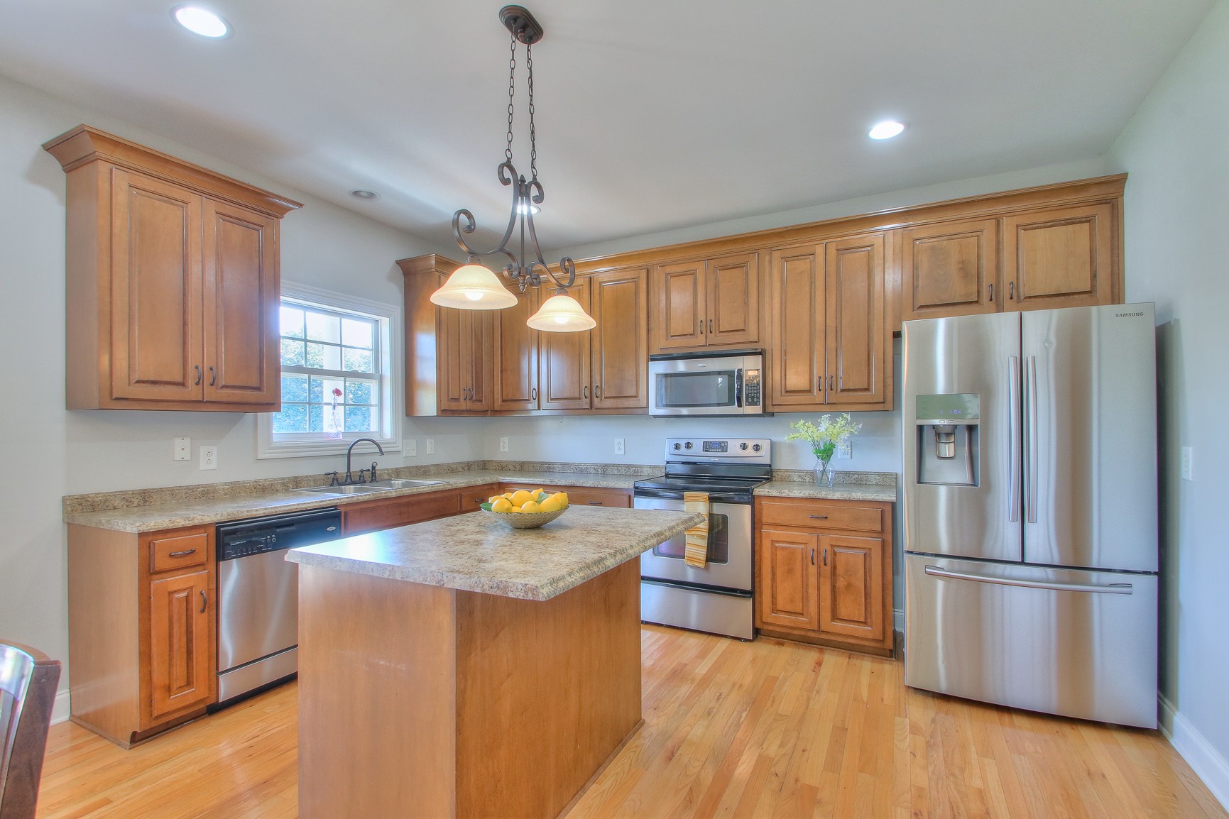 773 Sugar Flat Road Lebanon, TN 37087 - Photo 12 of 41 a kitchen with stainless steel appliances granite countertop a refrigerator a sink dishwasher a stove and white countertops with wooden floor