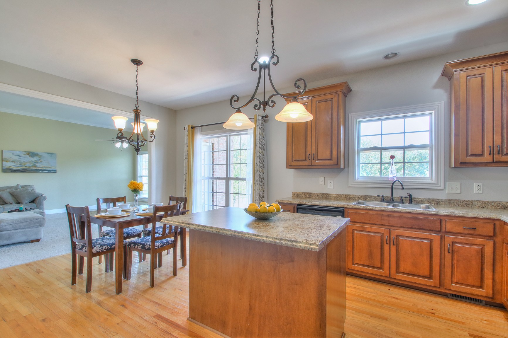773 Sugar Flat Road Lebanon, TN 37087 - Photo 17 of 41 a kitchen with a dining table chairs sink and cabinets
