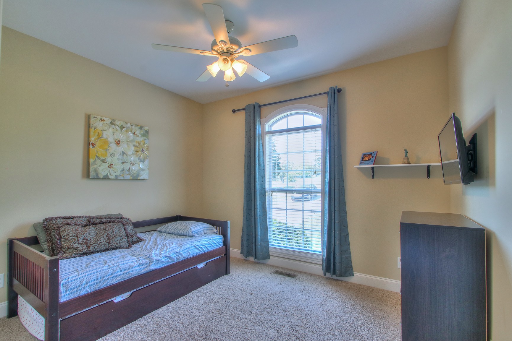 773 Sugar Flat Road Lebanon, TN 37087 - Photo 33 of 41 a bedroom with a bed and a chandelier