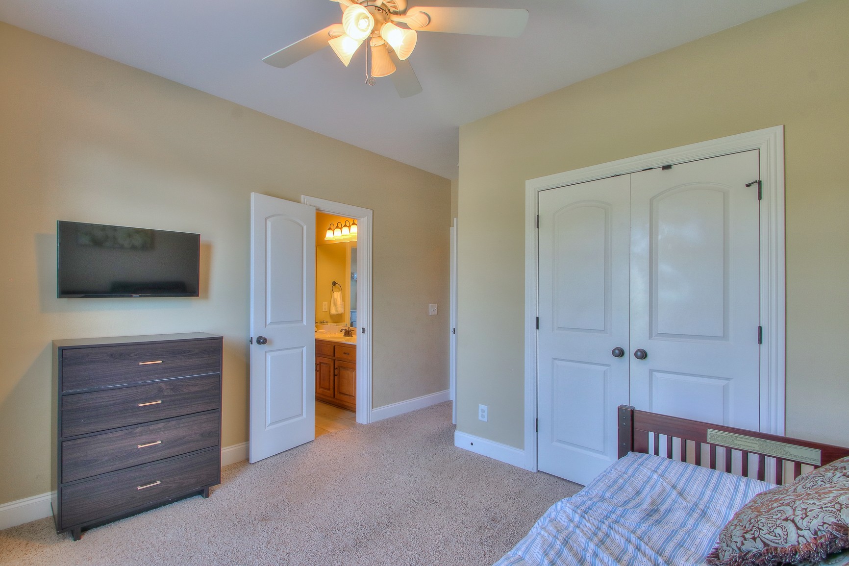 773 Sugar Flat Road Lebanon, TN 37087 - Photo 34 of 41 a bedroom with a bed and a flat tv screen on dresser