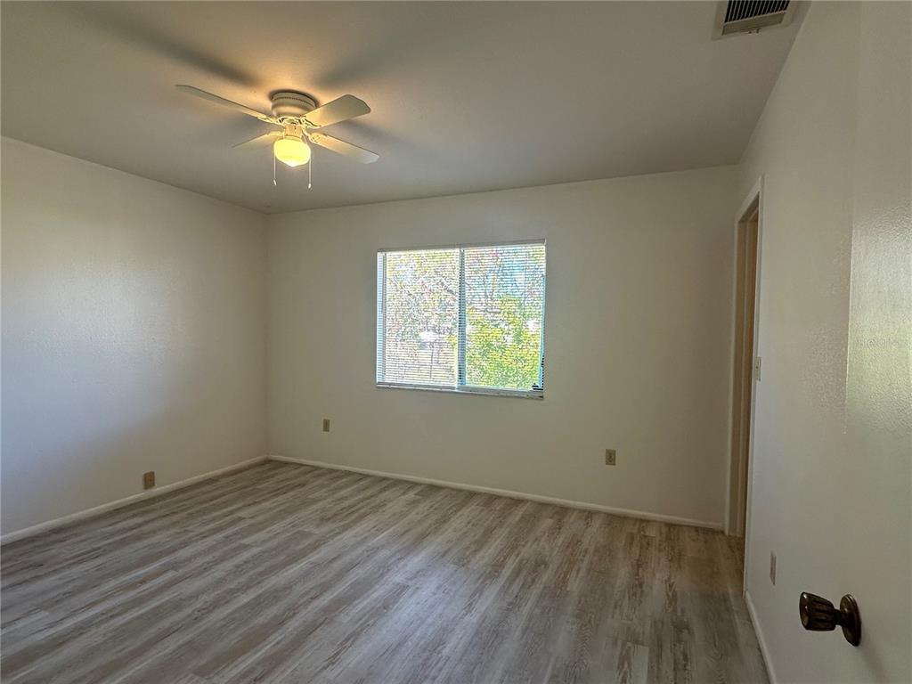 8100 Pickwick Road North Port, FL 34287 - Photo 14 of 15 an empty room with wooden floor and windows