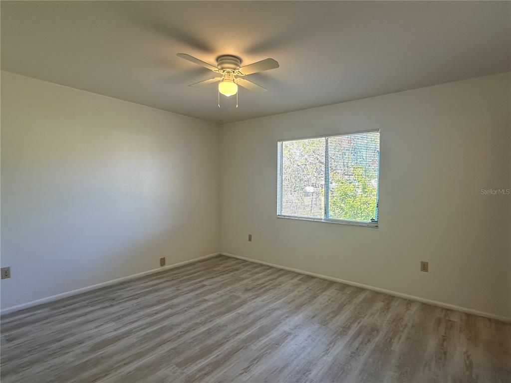 8100 Pickwick Road North Port, FL 34287 - Photo 4 of 15 an empty room with wooden floor and windows