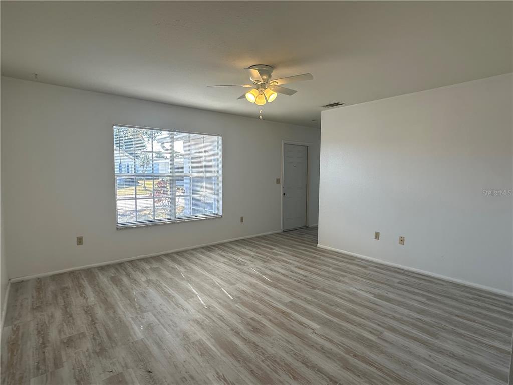 8100 Pickwick Road North Port, FL 34287 - Photo 6 of 15 wooden floor in an empty room with a window