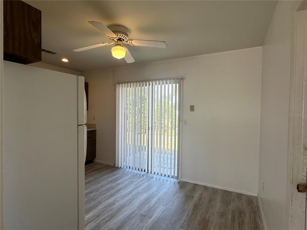 8100 Pickwick Road North Port, FL 34287 - Photo 7 of 15 a view of an empty room with wooden floor and a window