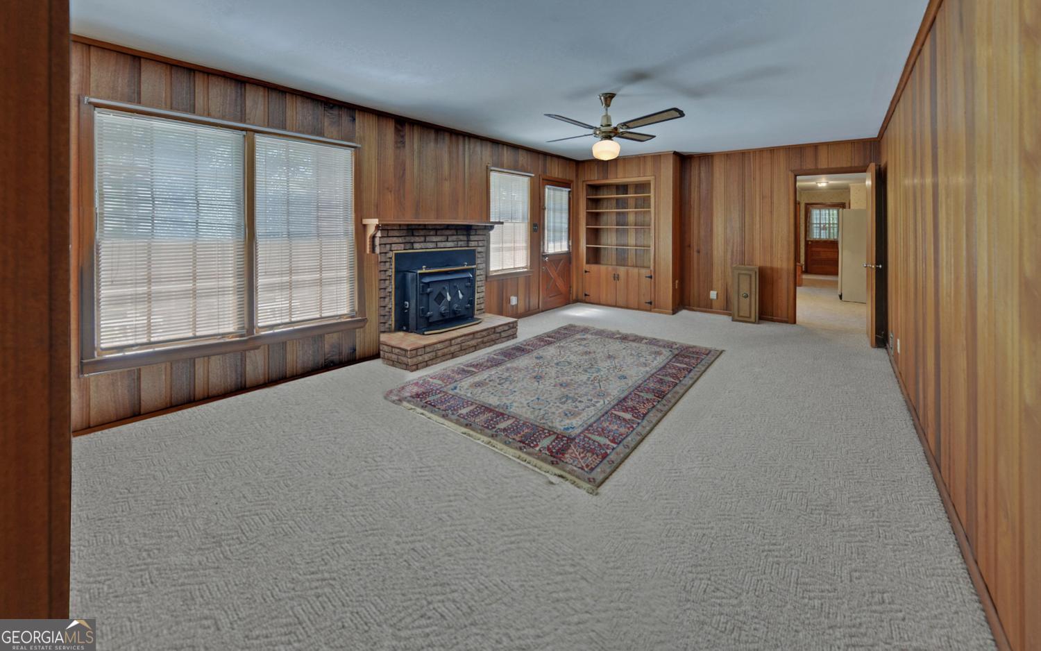 400 Harris Street Toccoa, GA 30577 - Photo 16 of 49 an empty room with furniture and a fireplace