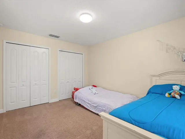 a bedroom with a bed and cabinets