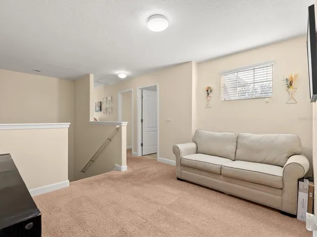 a living room with furniture and a air conditioner vent