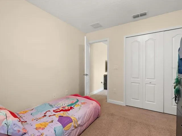 a bedroom with a bed and a cabinets