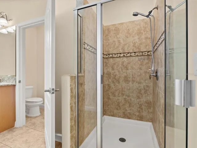 a bathroom with a shower and a toilet