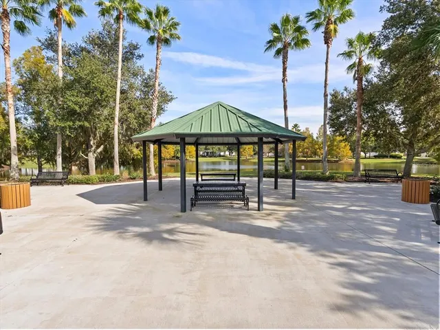 a view of a patio with a table chairs and a floor to ceiling window