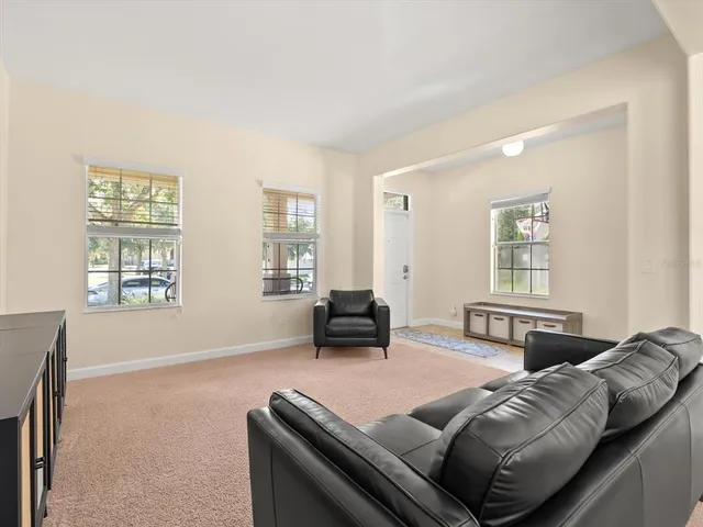 a living room with furniture and two window