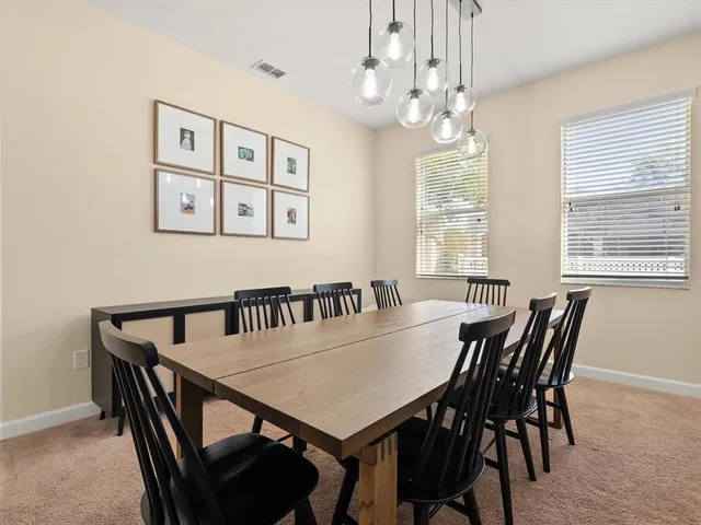 a view of a dining room with furniture and window