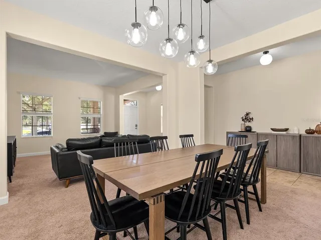 a view of a dining room with furniture and chandelier