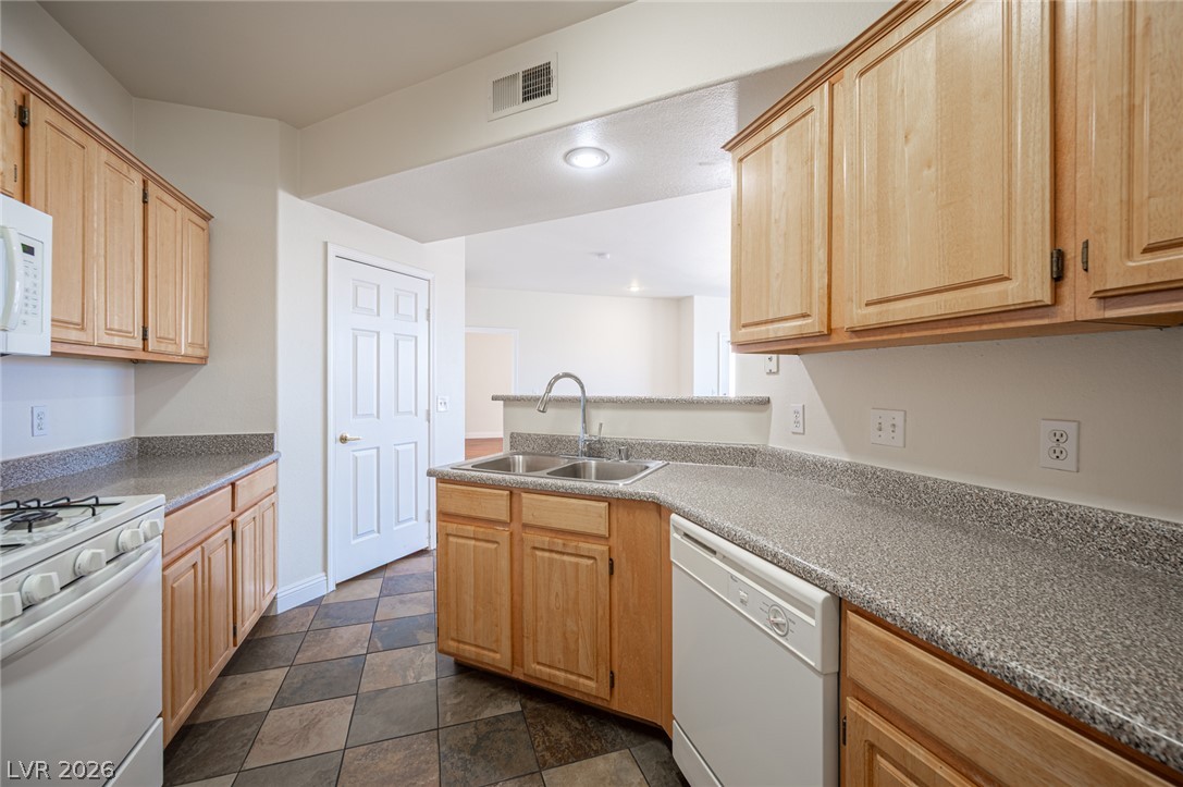 8555 West Russell Road, Unit 2062 Las Vegas, NV 89113 - Photo 18 of 35 An inviting kitchen with light wood cabinetry and durable countertops, perfect for daily living.