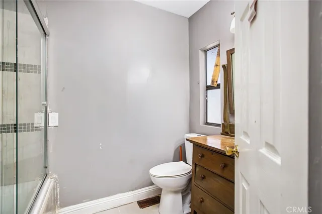 a bathroom with a toilet a sink and shower