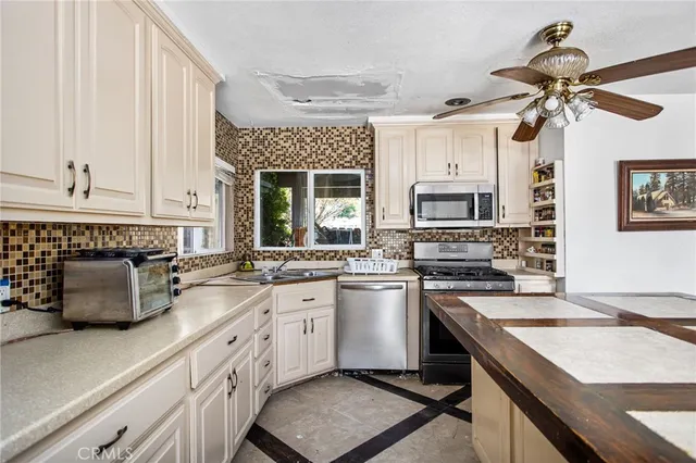 a kitchen with a sink stove and microwave