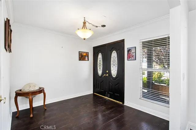 a view of a hallway with wooden floor and windows
