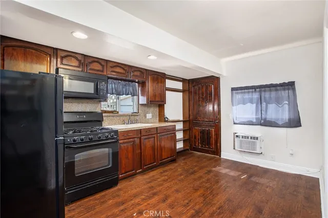 a kitchen with stainless steel appliances granite countertop a refrigerator stove top oven a sink and dishwasher