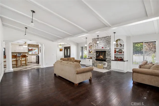 a living room with furniture wooden floor and a fireplace