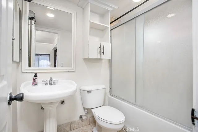 a bedroom with furniture and wooden floor