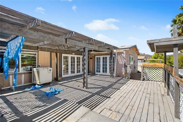a view of a patio with table and chairs and potted plants