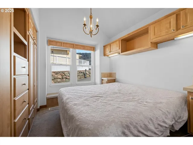 a bedroom with a bed a window and walk in closet