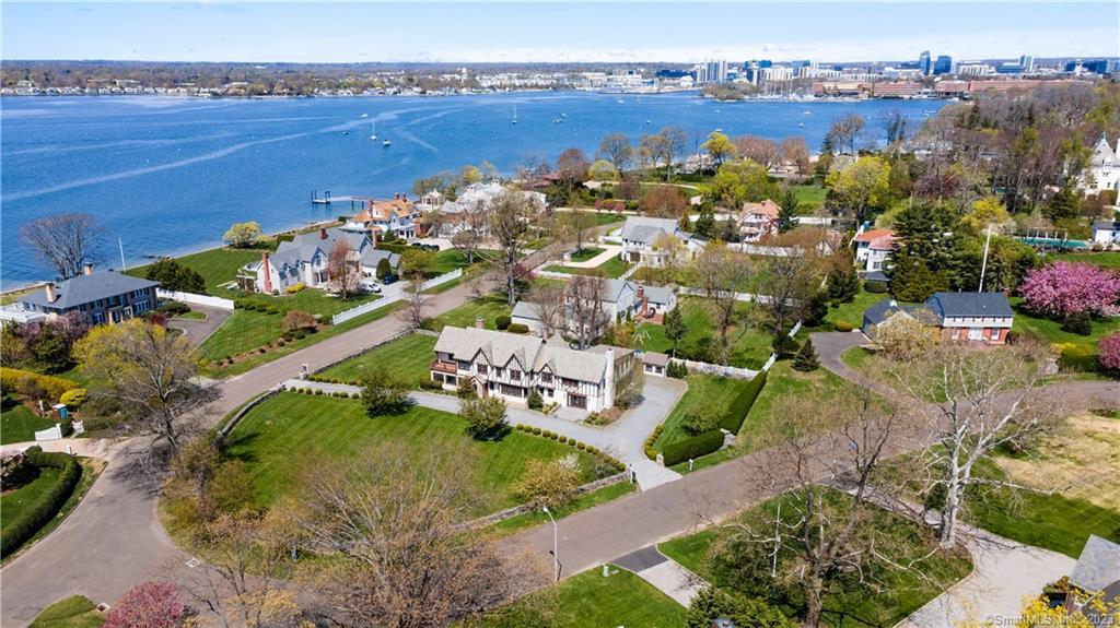 86 Rogers Road Stamford, CT 06902 - Photo 1 of 1 an aerial view of a house with a garden and lake view