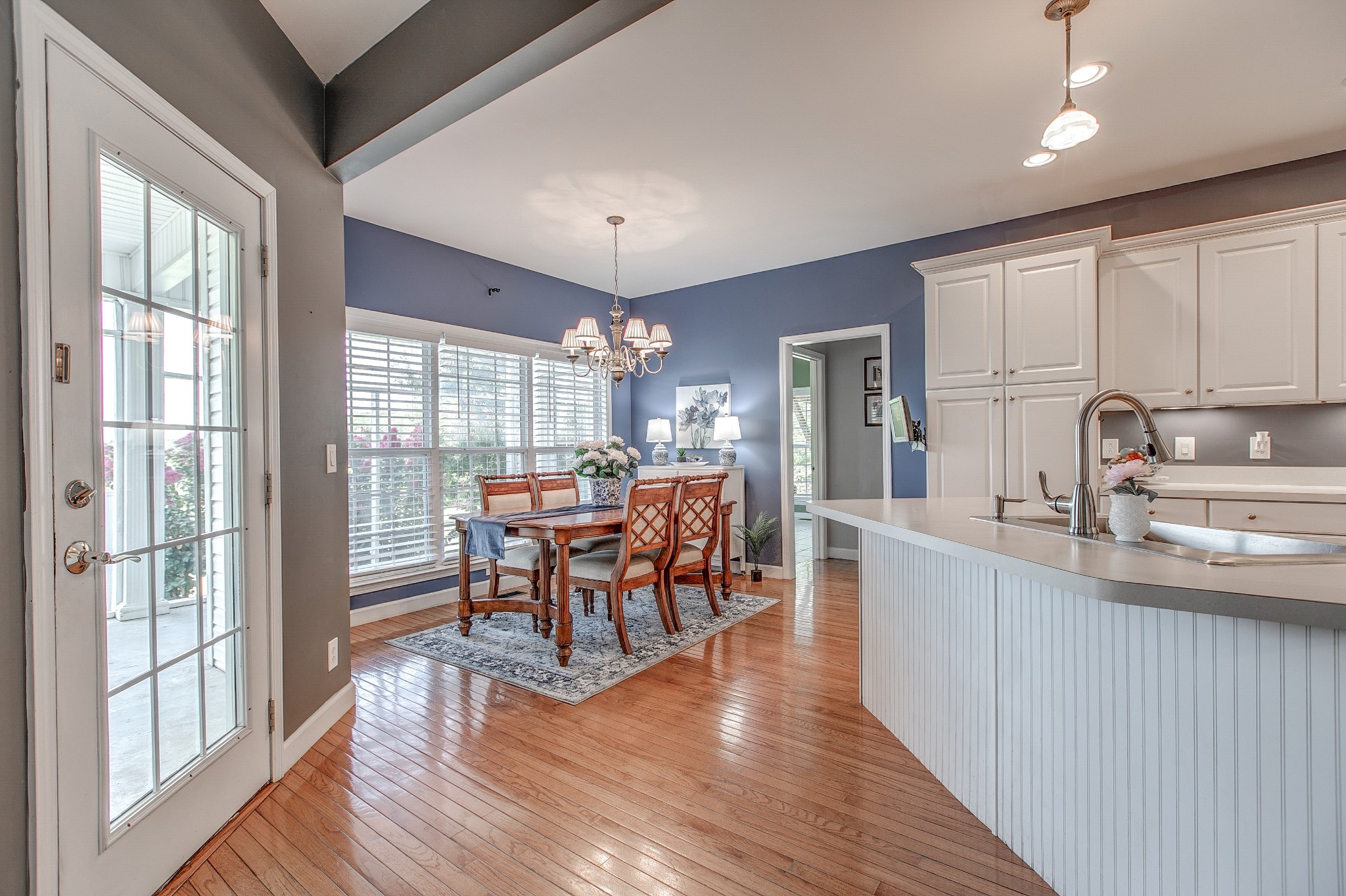 7285 North Milton Road Milton, TN 37118 - Photo 16 of 58 a kitchen with stainless steel appliances granite countertop a stove top oven a sink dishwasher a dining table and chairs with wooden floor