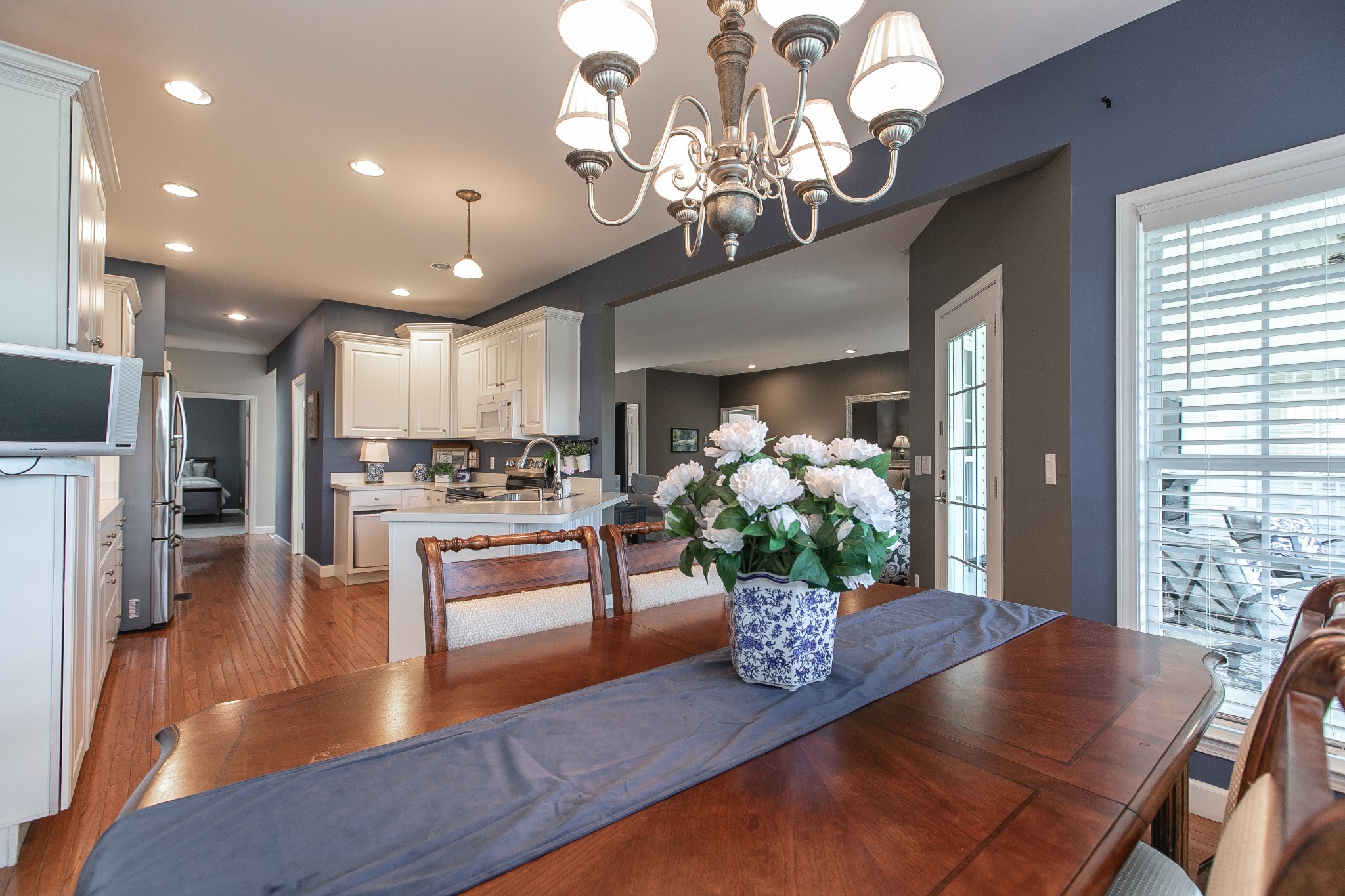 7285 North Milton Road Milton, TN 37118 - Photo 18 of 58 a living room with kitchen island furniture and a chandelier