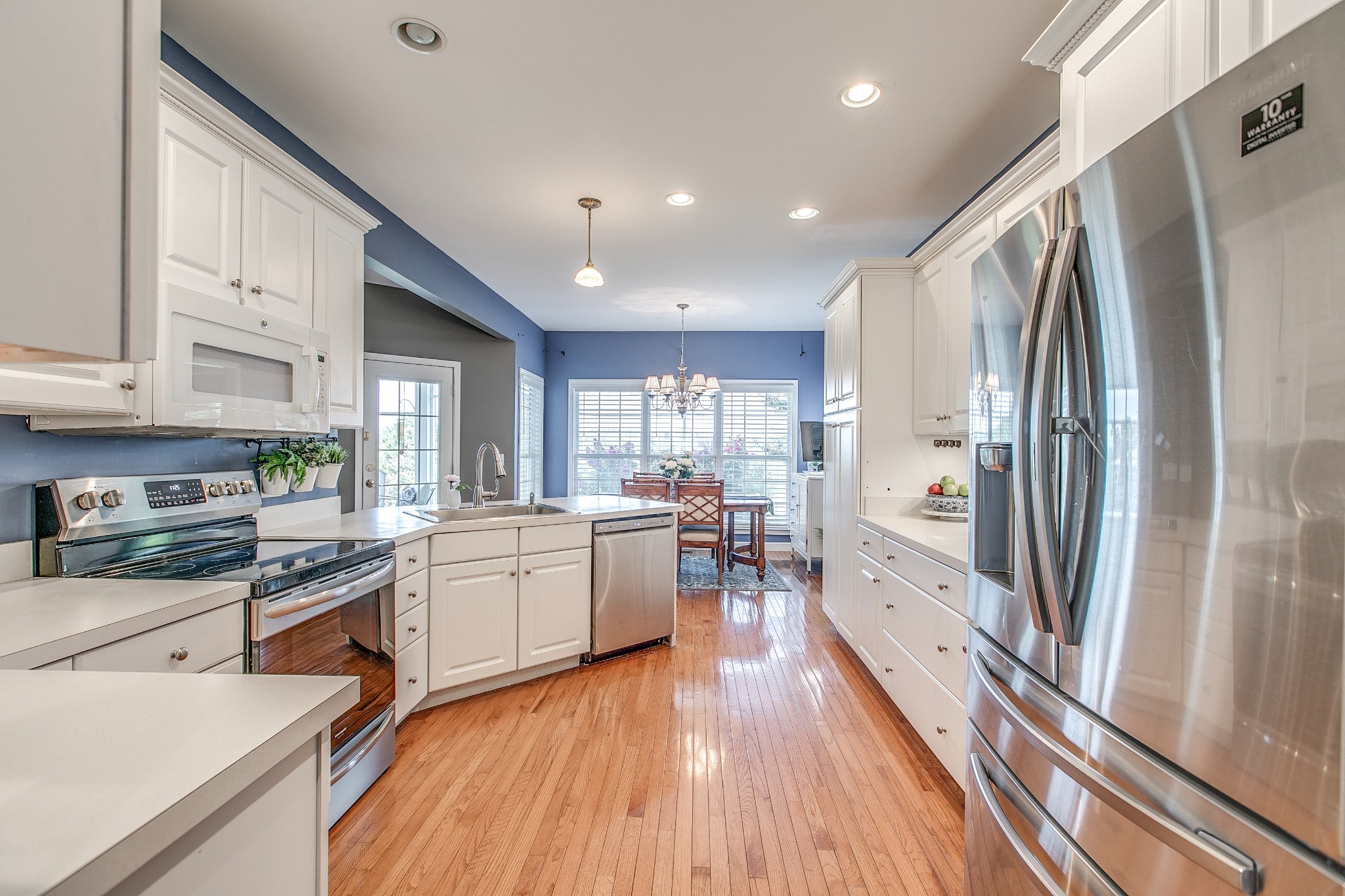 7285 North Milton Road Milton, TN 37118 - Photo 19 of 58 a kitchen with white cabinets and stainless steel appliances