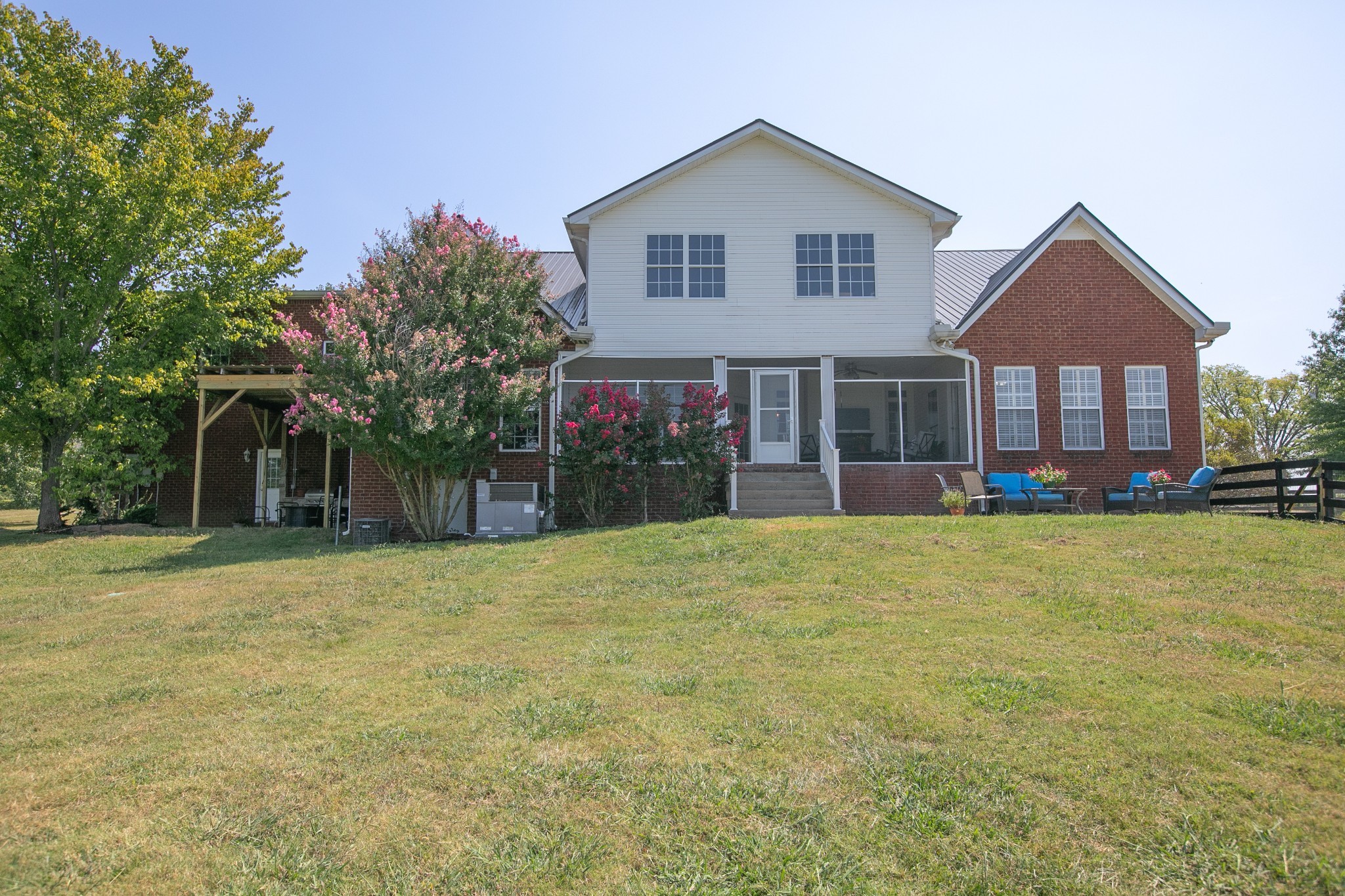7285 North Milton Road Milton, TN 37118 - Photo 46 of 58 a front view of a house with a garden and plants