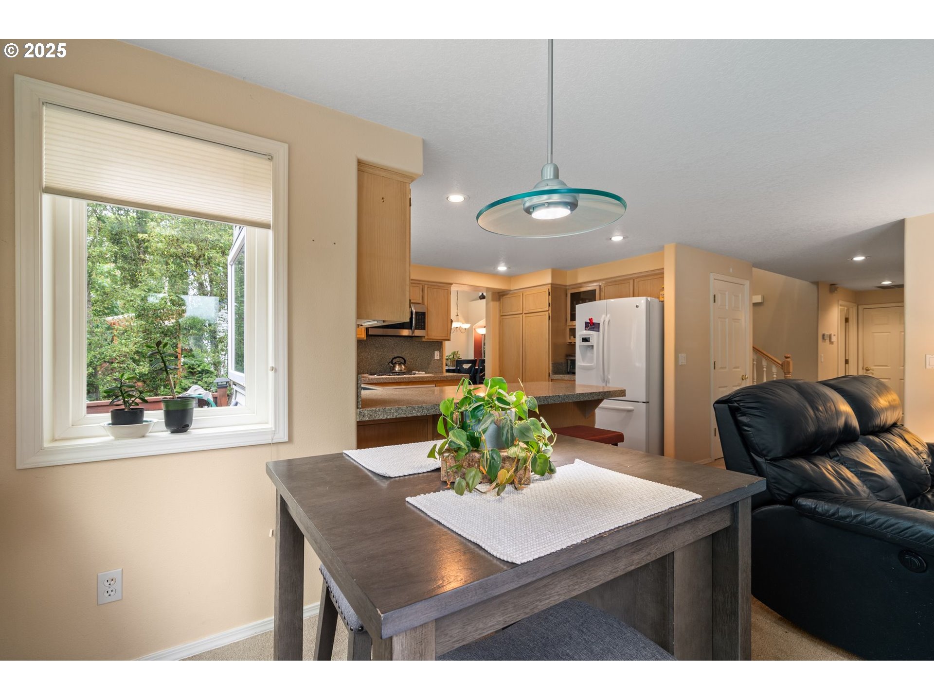 3010 Southwest Phyllis Drive Gresham, OR 97080 - Photo 16 of 48 a kitchen with a table chairs and white cabinets