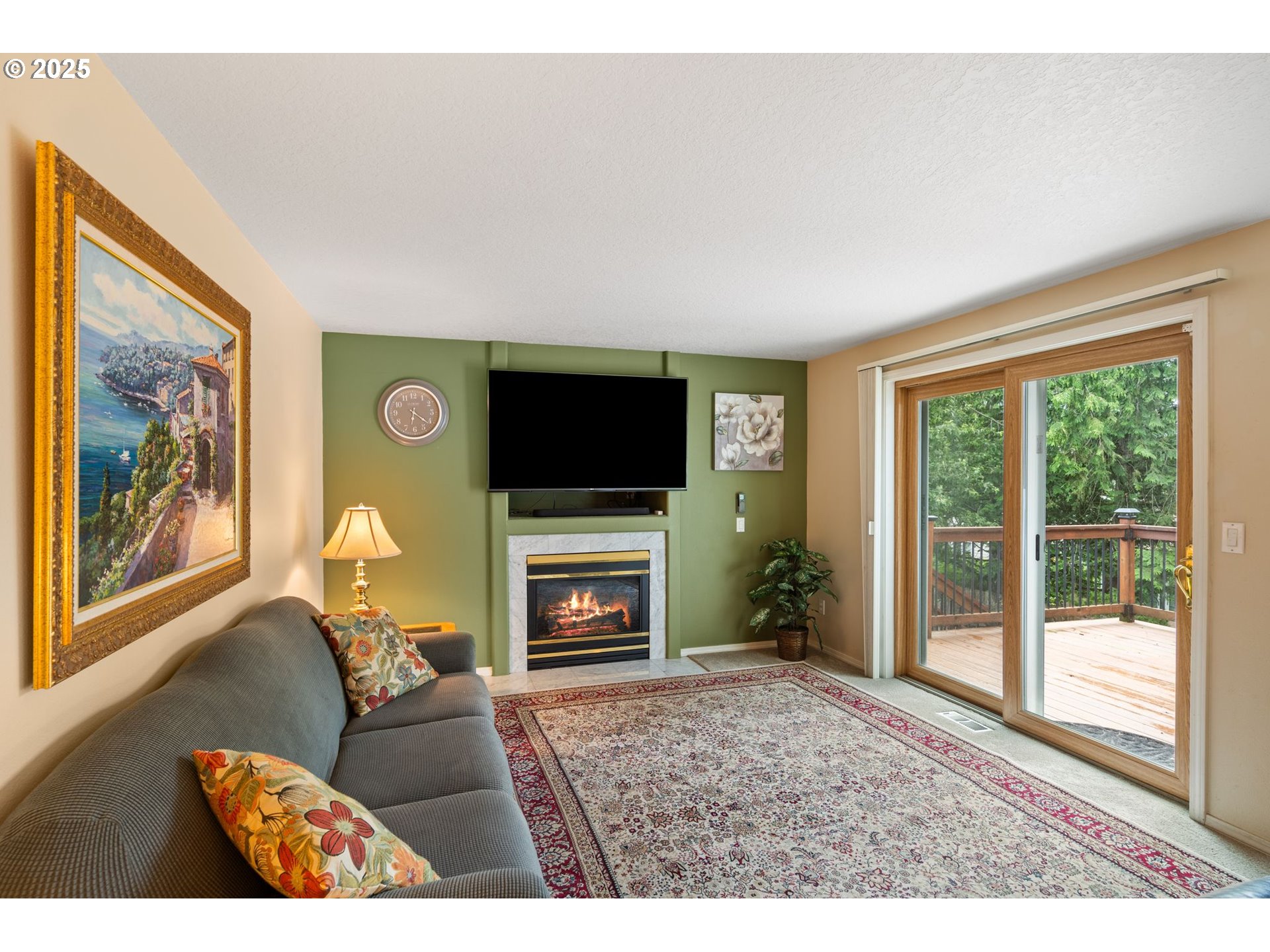 3010 Southwest Phyllis Drive Gresham, OR 97080 - Photo 20 of 48 a living room with furniture a flat screen tv and a fireplace