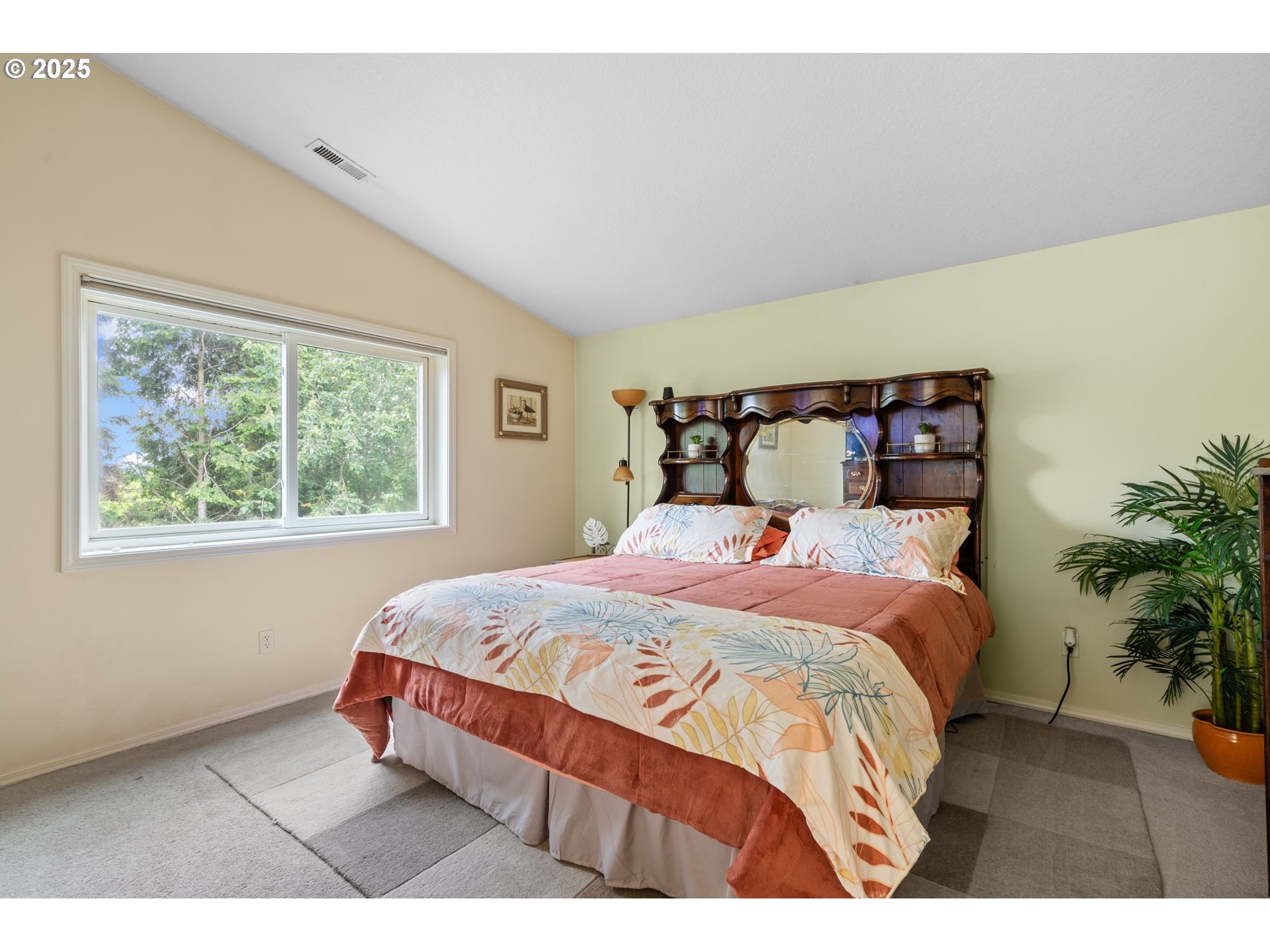 3010 Southwest Phyllis Drive Gresham, OR 97080 - Photo 32 of 48 a bedroom with a large bed and a potted plant