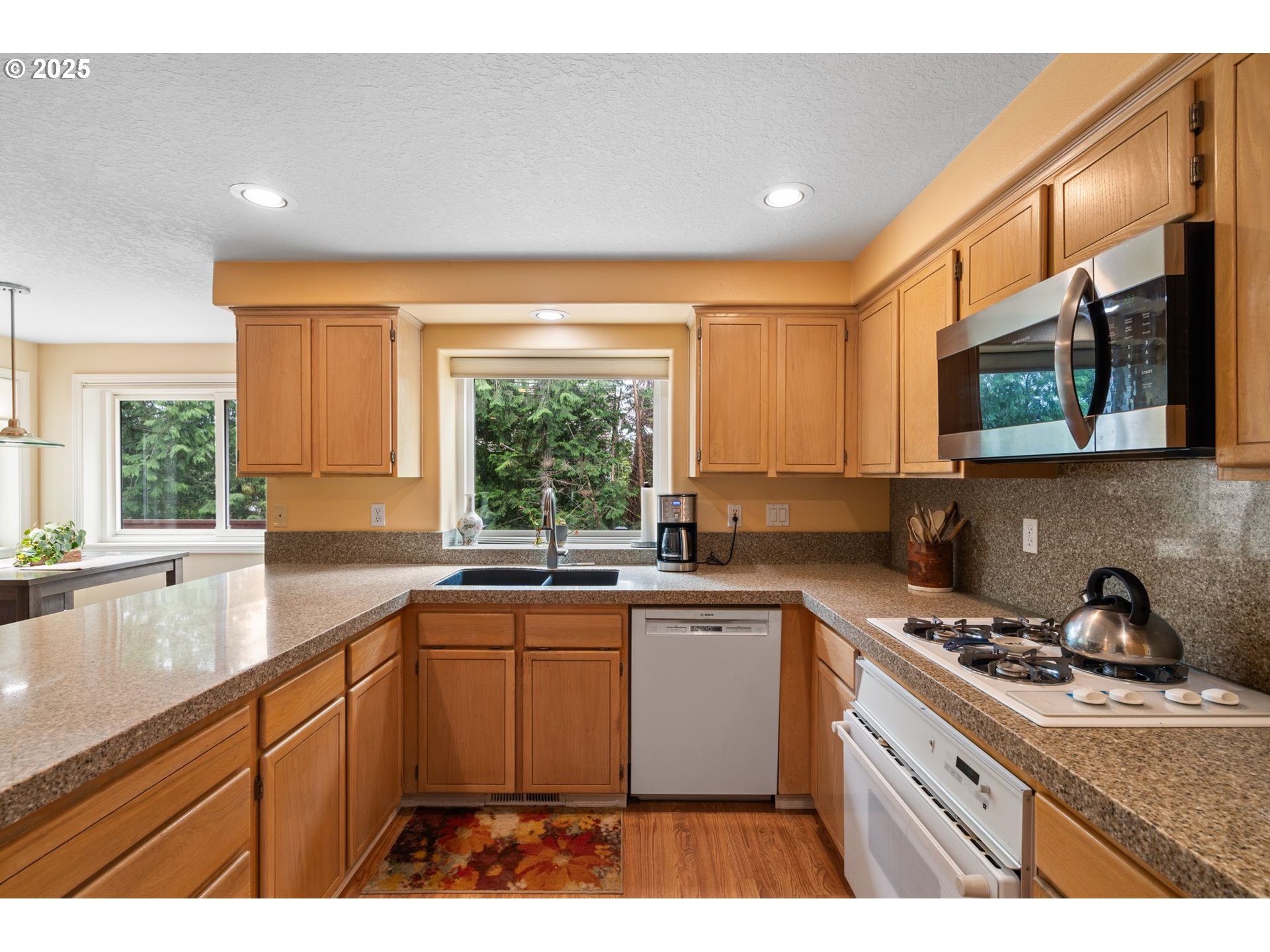 3010 Southwest Phyllis Drive Gresham, OR 97080 - Photo 9 of 48 a kitchen with a sink stove and microwave