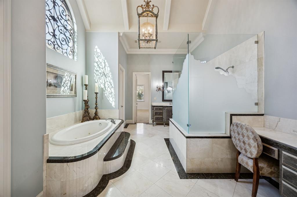 6640 Briar Ridge Lane Plano, TX 75024 - Photo 23 of 40 Light and bright Primary bathroom, frosted glass shower, beamed ceiling, travertine flooring and built-in vanity areas