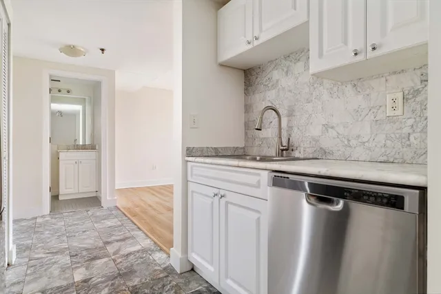 a view of a sink and a refrigerator