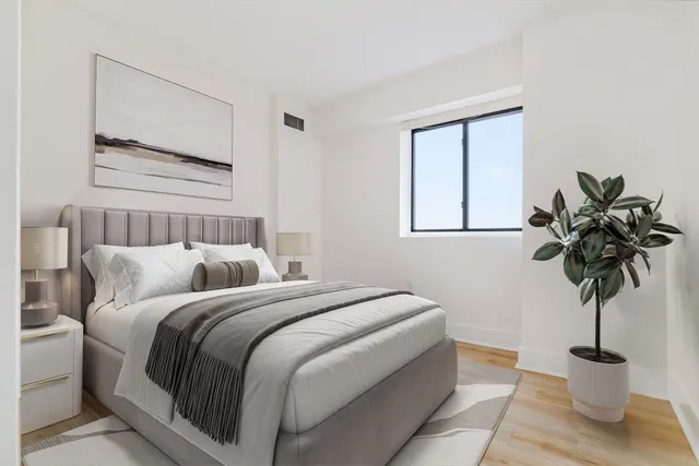 a bedroom with a bed and a window