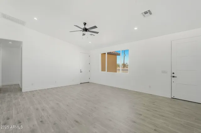 a kitchen with kitchen island granite countertop a sink stove and refrigerator