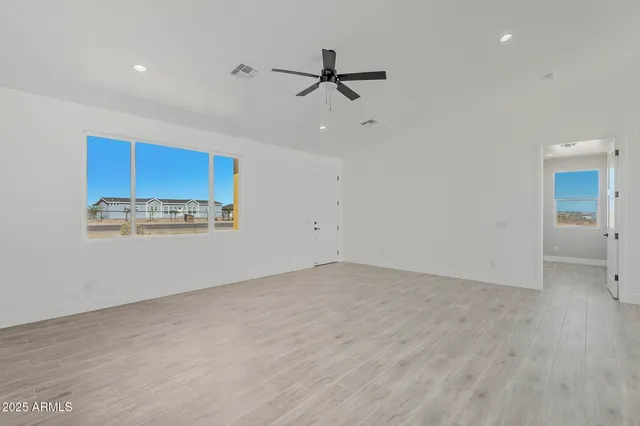 a view of a room with wooden floor and window