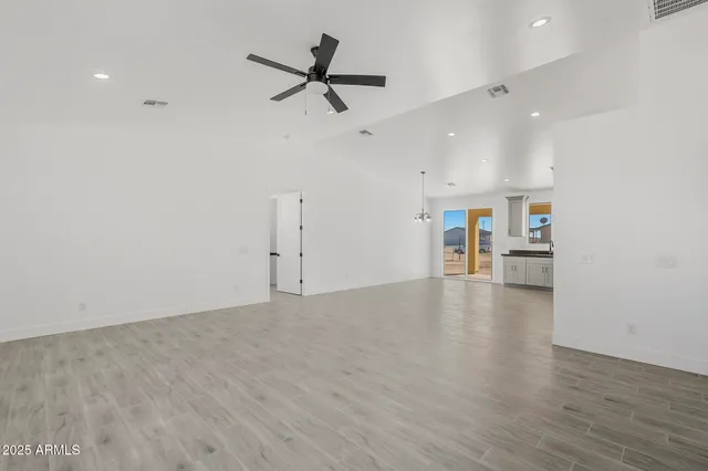 a view of kitchen with stainless steel appliances granite countertop a sink and cabinets