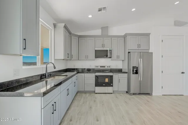 a view of a livingroom with wooden floor and a ceiling fan