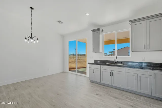a view of a big room with wooden floor and windows