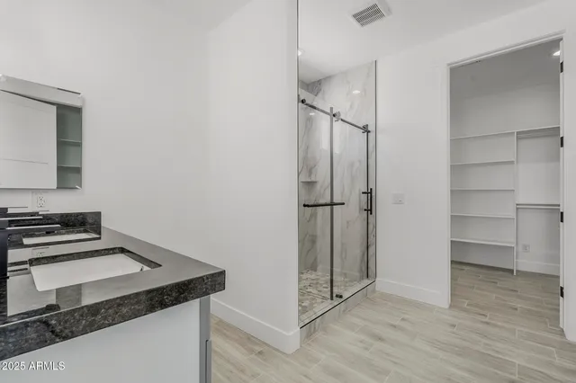 a view of a big room with wooden floor and windows in a room