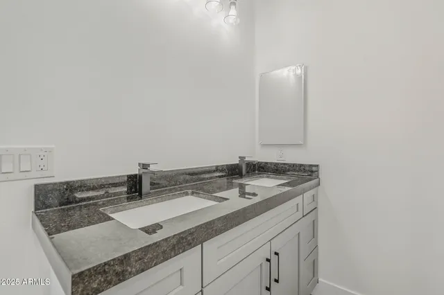 a view of hallway with a ceiling fan and wooden floor