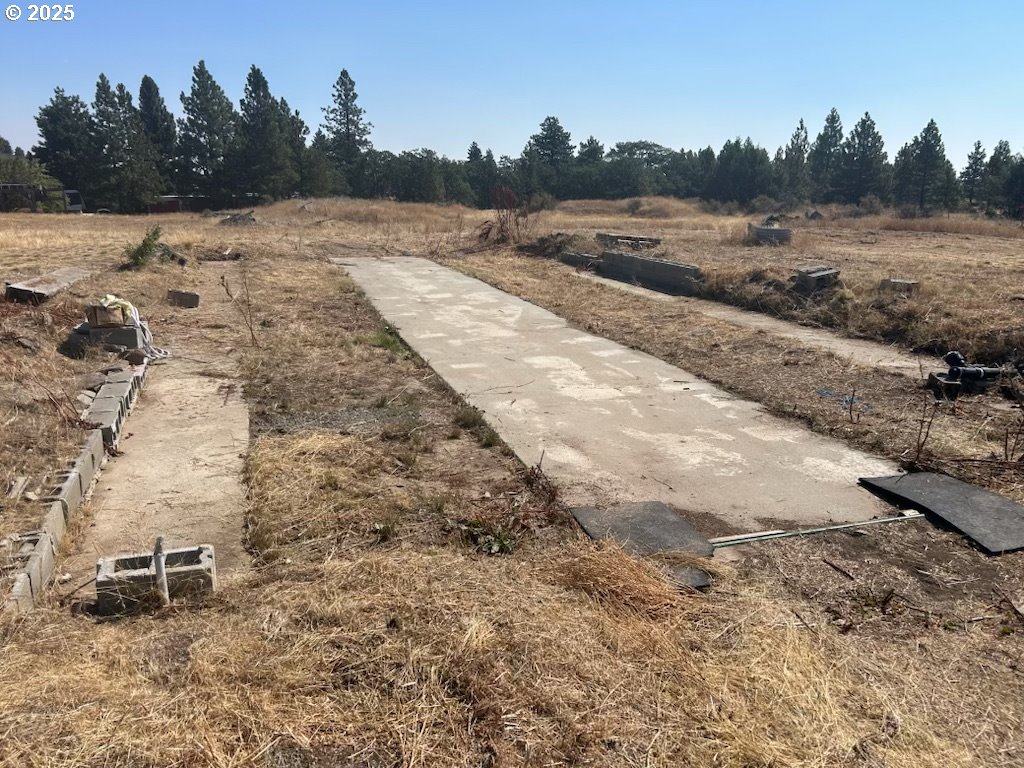 23 Bickleton Highway Roosevelt, WA 99356 - Photo 3 of 12 a view of a dry yard with wooden fence
