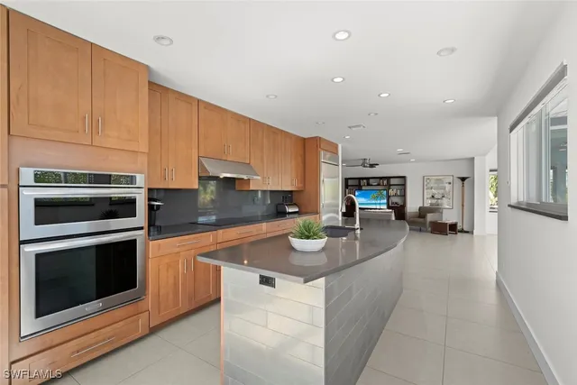a kitchen with stainless steel appliances granite countertop a sink stove and cabinets