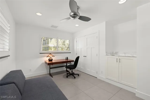 a view of a livingroom with workspace and a window